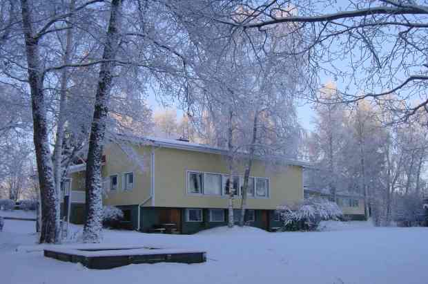 Järvelä main building in winter, viewed from the lake shore